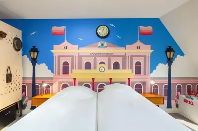a room with a large building with a clock on the wall at Stayokay Hostel Utrecht Centrum in Utrecht