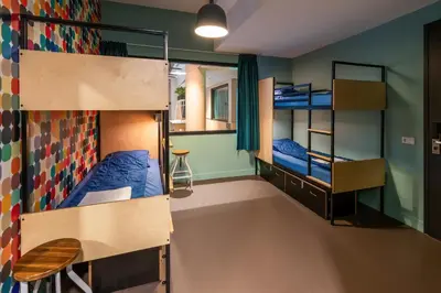 a room with two bunk beds and a desk at Stayokay Hostel Utrecht Centrum in Utrecht