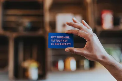 a person holding up a cup with their hand at Stayokay Hostel Utrecht Centrum in Utrecht