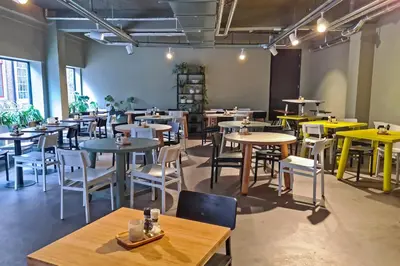a room with tables and chairs in a restaurant at Stayokay Hostel Utrecht Centrum in Utrecht