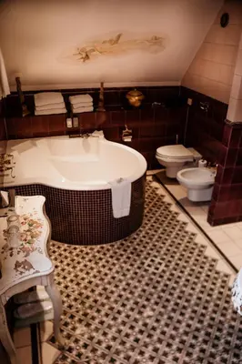 a bathroom with a large tub and a toilet at Villa Beukenhof in Oegstgeest