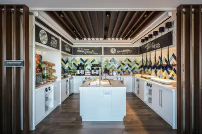 a large kitchen with white cabinets and a counter at Hampton by Hilton Amsterdam Centre East in Amsterdam