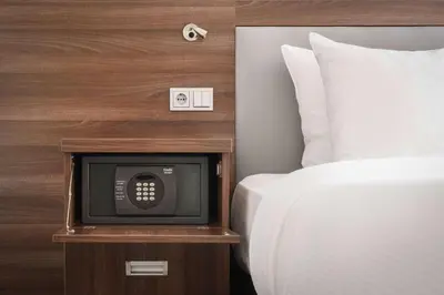 a small television sitting on a night stand next to a bed at Hampton by Hilton Amsterdam Centre East in Amsterdam