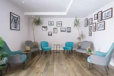 a waiting room with chairs and pictures on the wall at Hampton by Hilton Amsterdam Centre East in Amsterdam