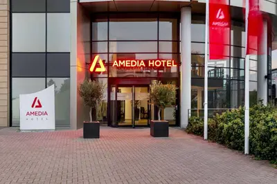 aania hotel with a sign in front of a building at Amedia Amsterdam Airport Schiphol, Trademark Collection by Wyndham in Schiphol