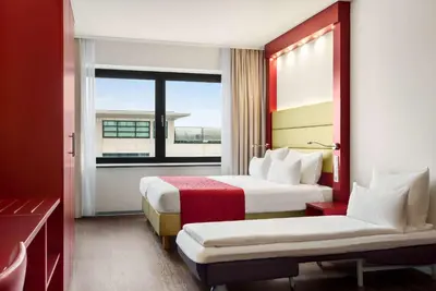 a hotel room with two beds and a window at Amedia Amsterdam Airport Schiphol, Trademark Collection by Wyndham in Schiphol