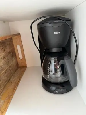 a black coffee maker sitting on top of a counter at Beach House Sea-Esta in Egmond aan Zee
