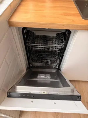 an empty dishwasher in the middle of a kitchen drawer at Beach House Sea-Esta in Egmond aan Zee