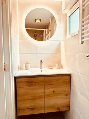 a bathroom with a sink and a mirror at Beach House Sea-Esta in Egmond aan Zee