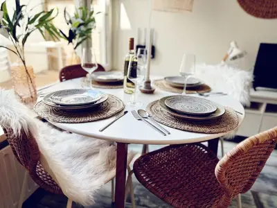 a white table with chairs and plates on it at Beach House Sea-Esta in Egmond aan Zee