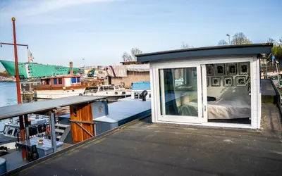 a small house on the back of a boat at Houseboat-Amsterdam in Amsterdam