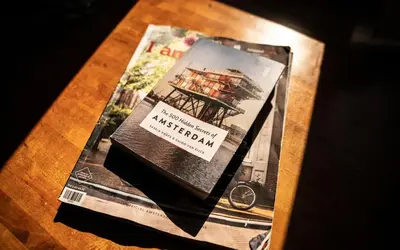 a magazine sitting on top of a table at Houseboat-Amsterdam in Amsterdam