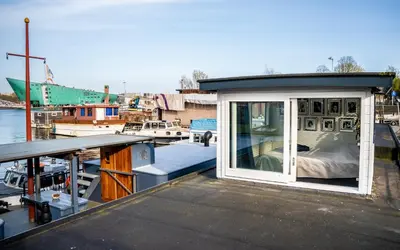 a small house on a boat at a marina at Houseboat-Amsterdam in Amsterdam
