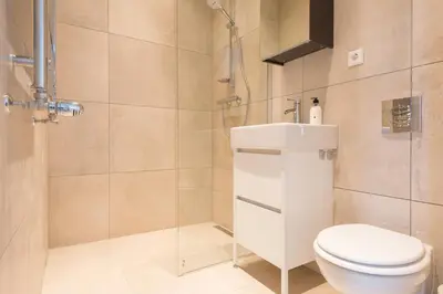 a bathroom with a shower and a toilet and a sink at Happy Day´s in Amsterdam