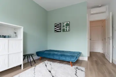 a blue bench in a room with a white wall at Happy Day´s in Amsterdam