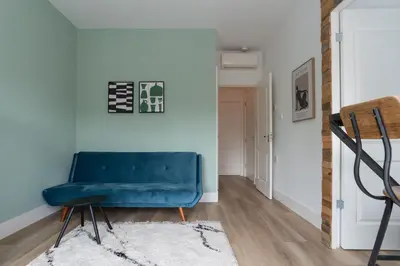 a blue bench in a room with a blue wall at Happy Day´s in Amsterdam