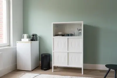 a white cabinet in a room next to a window at Happy Day´s in Amsterdam