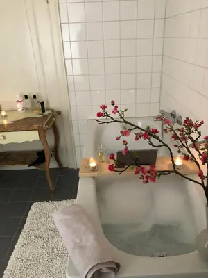 a bathroom with a bath tub with a tree in it at Proeverij de Azijnmakerij in Zeist