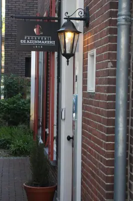 a street light on the side of a brick building at Proeverij de Azijnmakerij in Zeist