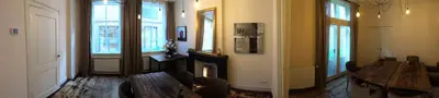 a living room with a table and a fireplace at Proeverij de Azijnmakerij in Zeist