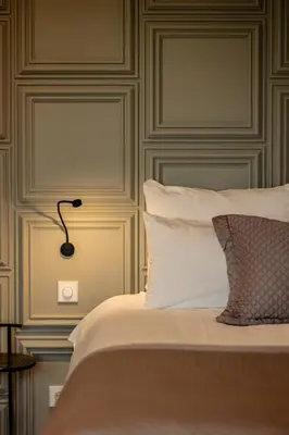 a bedroom with a bed with a lamp on it at Boutique Hotel De Witte Dame in Abcoude