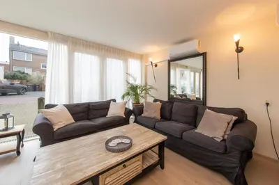 a living room with a couch and a coffee table at Blankebil Studios & Apartments in Zandvoort