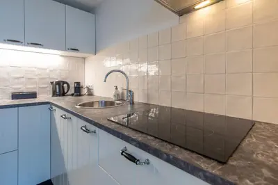 a kitchen with a sink and a counter top at Blankebil Studios & Apartments in Zandvoort