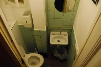 a small bathroom with a toilet and a sink at Hotel Tamara in Amsterdam
