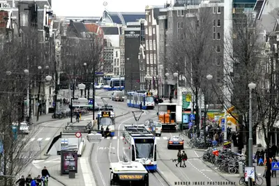 a busy city street with cars and buses at Hotel Tamara in Amsterdam
