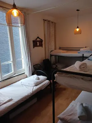 a room with three bunk beds and a window at Hotel Tamara in Amsterdam