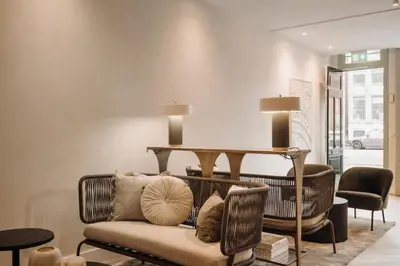 a living room with a couch and a table at Adam Suites Hotel in Amsterdam