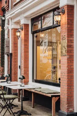 a store window with a bench in front of it at Adam Suites Hotel in Amsterdam