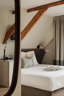a bedroom with a white bed and a mirror at Adam Suites Hotel in Amsterdam