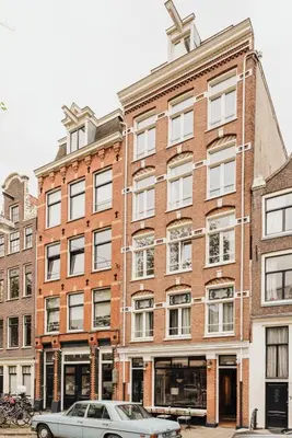 a car parked in front of a brick building at Adam Suites Hotel in Amsterdam