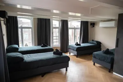 a living room with two beds and a couch at Hotel 83 in Amsterdam