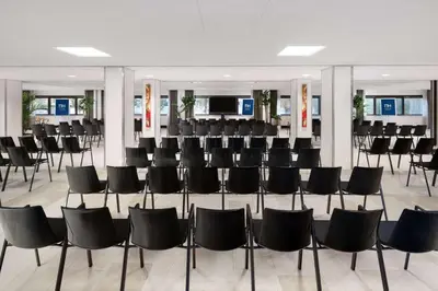a conference room with black chairs in a building at NH Amsterdam Zuid in Amsterdam