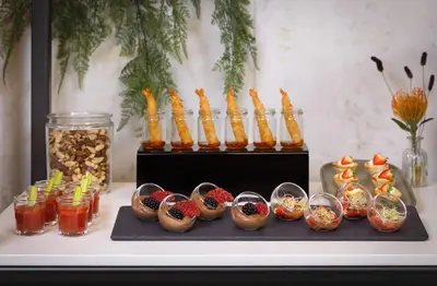 a table topped with different types of food and drinks at NH Amsterdam Zuid in Amsterdam