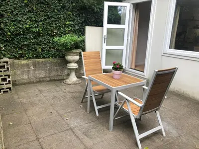 a table and two chairs sitting next to a window at Apartment Ella with free privat parking in Zandvoort