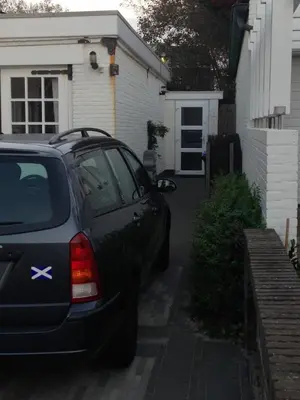 a car parked in the driveway of a house at Apartment Ella with free privat parking in Zandvoort