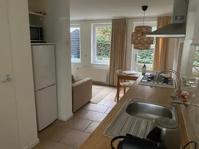 a kitchen with a sink and a counter top at Apartment Ella with free privat parking in Zandvoort