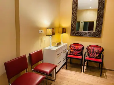 a waiting room with two chairs and a mirror at Red light district B & B canal view in Amsterdam