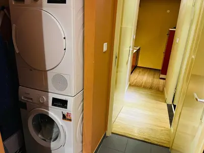 a washer and dryer in a room with a hallway at Red light district B & B canal view in Amsterdam