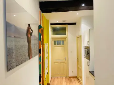 a hallway with a door and a painting on the wall at Red light district B & B canal view in Amsterdam