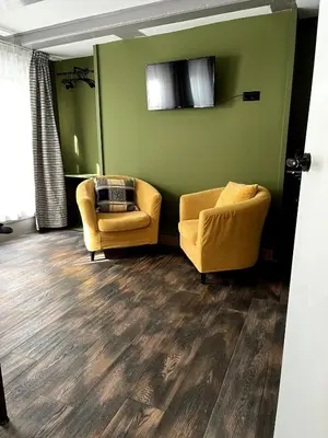 a living room with two chairs and a couch at Central Guest Rooms in Amsterdam