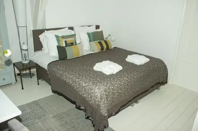 a bedroom with a bed with two towels on it at NR22 Leiden in Leiden