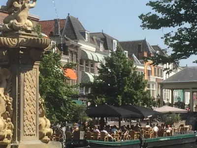 a group of tables and umbrellas in a city at NR22 Leiden in Leiden