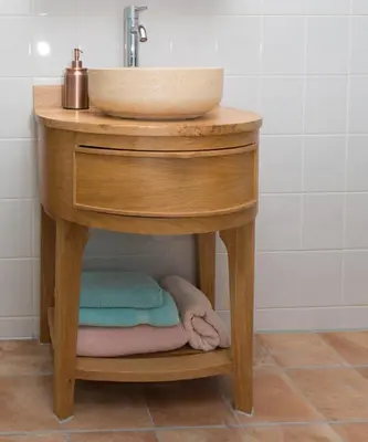 a wooden bathroom sink with towels under it at El Puerto Bed and Breakfast in Hoorn