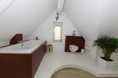 a bathroom with a sink and a toilet and a bath tub at El Puerto Bed and Breakfast in Hoorn