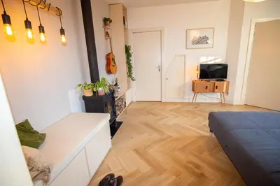 a living room with a couch and a television at Cute Beach House Zandvoort in Zandvoort