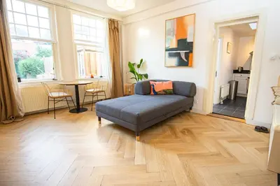 a living room with a couch and a table at Cute Beach House Zandvoort in Zandvoort
